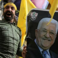 Fatah member with a photo of Mahmoud Abbas