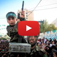 A Palestinian child holding a machine gun at a Hamas rally in the Gaza Strip