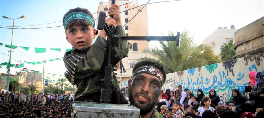 A Palestinian child holding a machine gun at a Hamas rally in the Gaza Strip