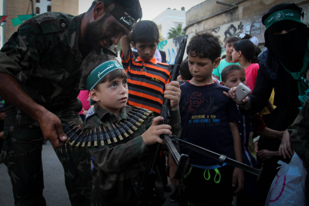 Palestinian boy with machine gun at a Hamas camp