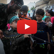 Palestinian boy with machine gun at a Hamas camp