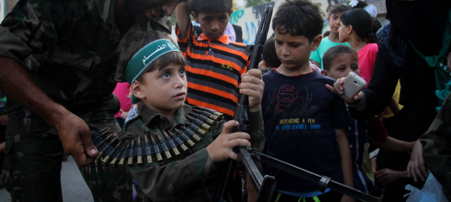 Palestinian boy with machine gun at a Hamas camp