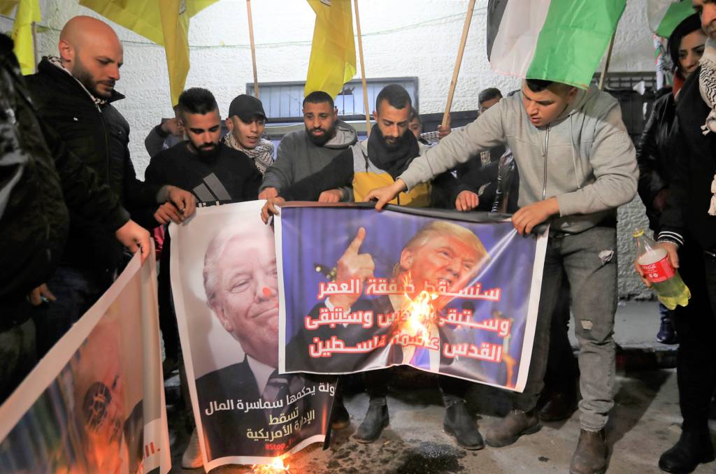 Palestinians burn pictures of Trump.