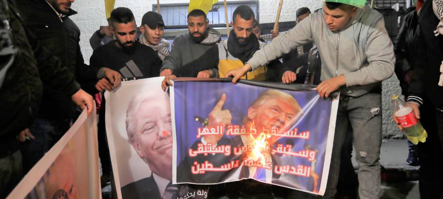 Palestinians burn pictures of Trump.