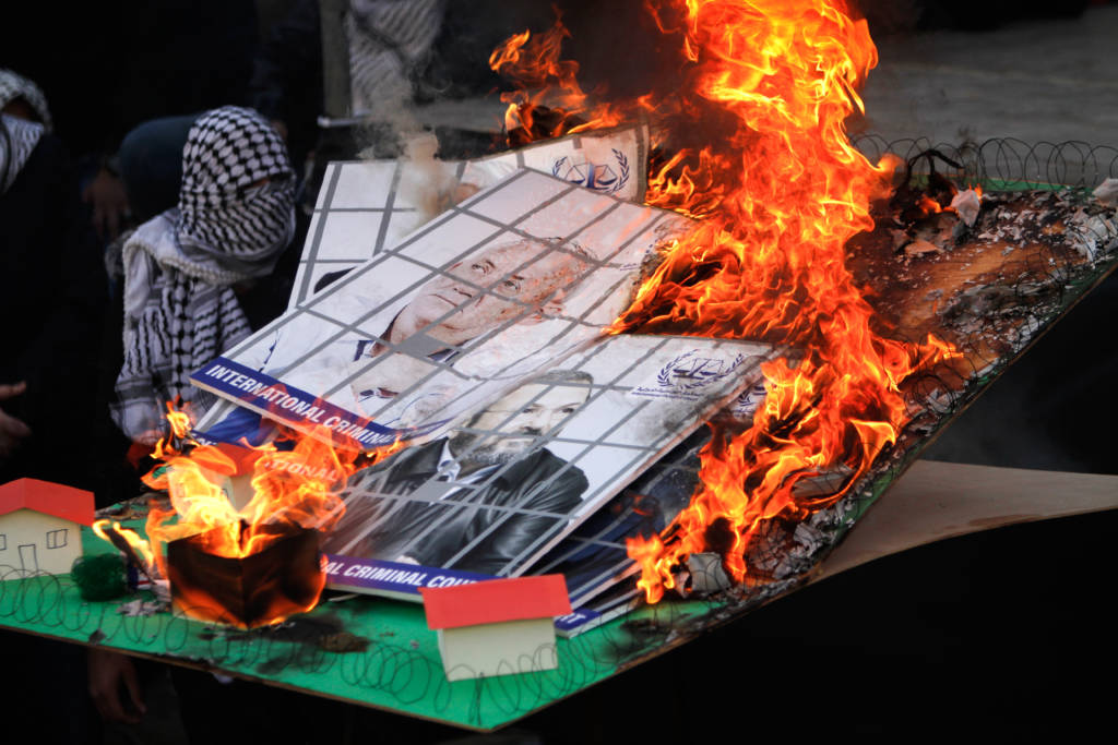 Fatah supporters burn a model of an Israeli Jewish community and images of Israeli political leaders during a rally to celebrate the 55th anniversary of the founding of the Fatah movement, in Shechem (Nablus), on January 6, 2020.