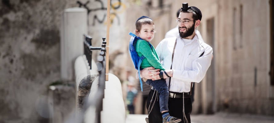 Jewish father carries his son.