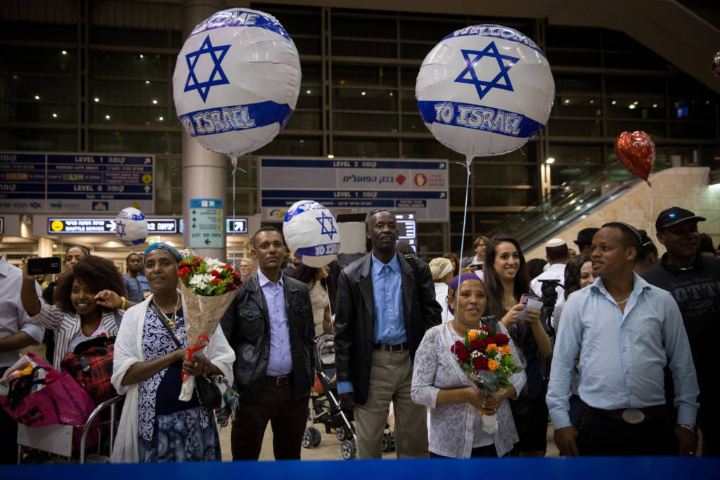 Israelis wait at Ben Gurion Airport for family members immigrating from Ethiopia