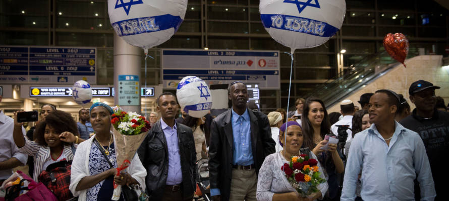Israelis wait at Ben Gurion Airport for family members immigrating from Ethiopia