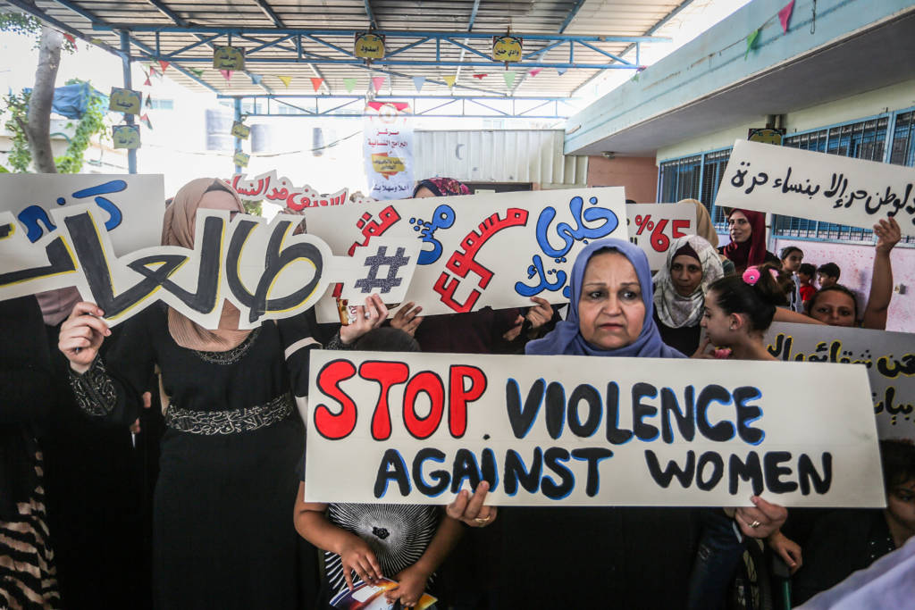 Palestinian women participate in the protest against violence against women