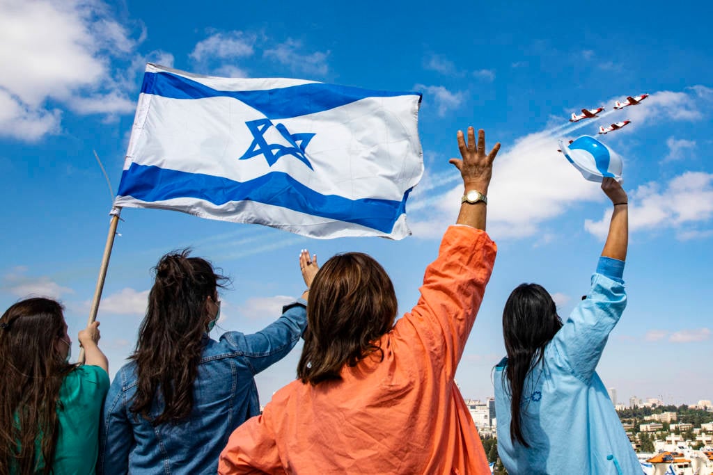 Israeli medical staff cheer an Israeli Air Force acrobatic team.