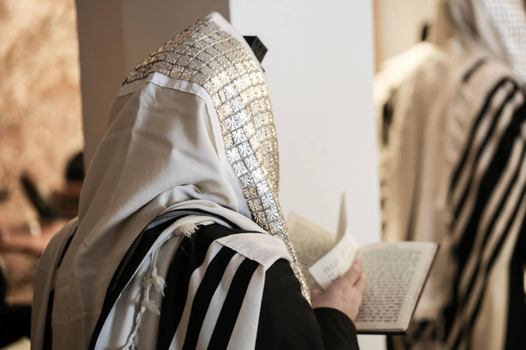 jewish man praying with talit