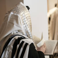 jewish man praying with talit