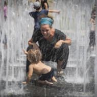 Children play in a water fountain