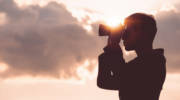 man looking through binoculars