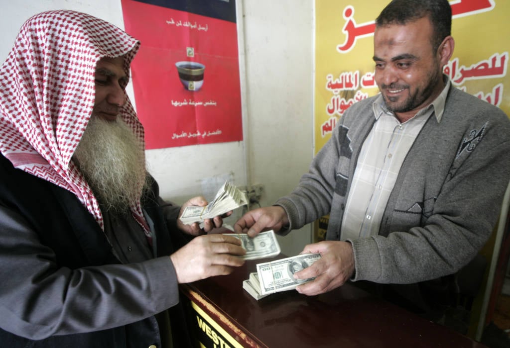 Palestinian man exchanges currency