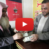 Palestinian man exchanges currency