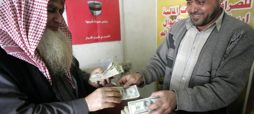 Palestinian man exchanges currency