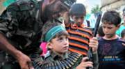 Palestinian boy holds a weapon