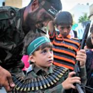 Palestinian boy holds a weapon