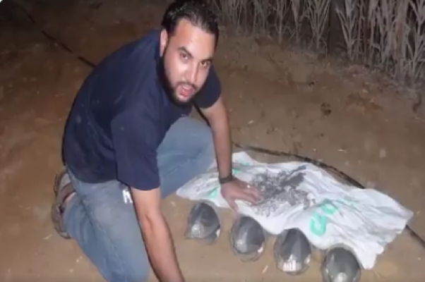 Hamas terrorist burying rockets