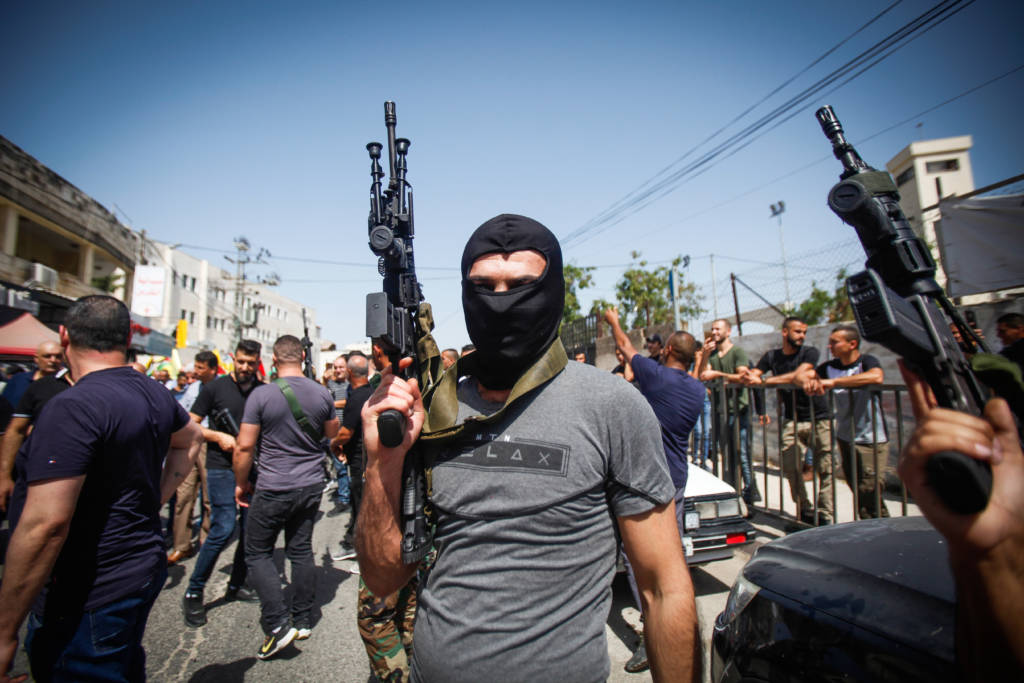 Masked Palestinians hold their guns