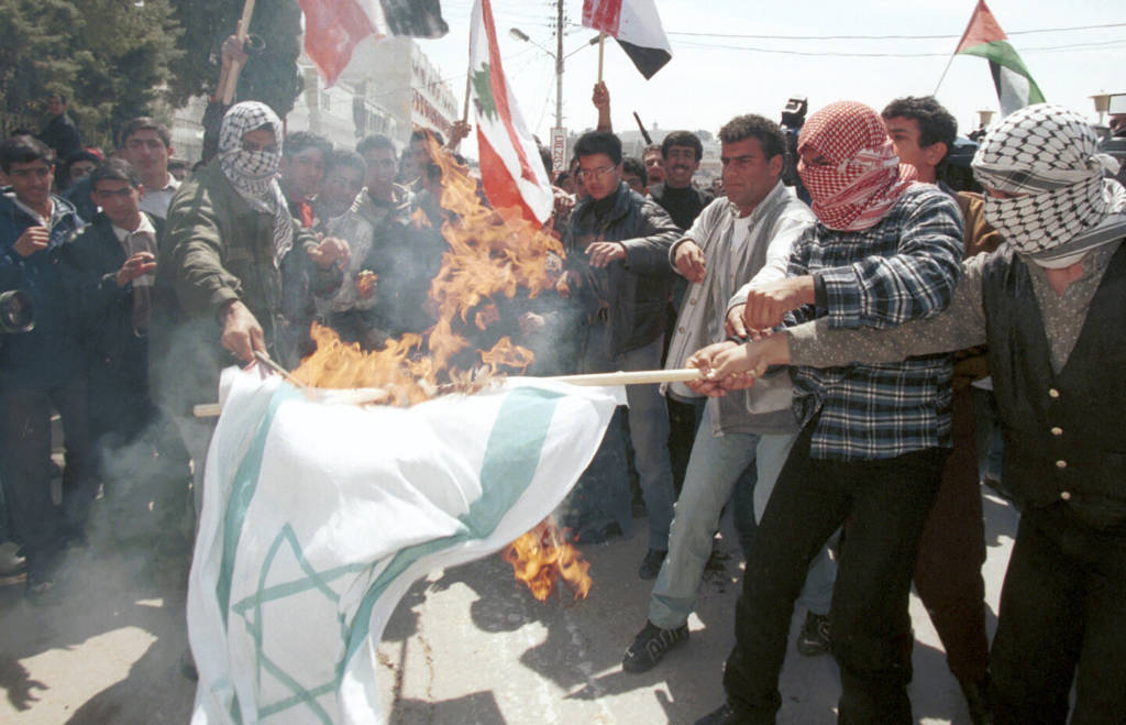 Palestinians burn the Israeli flag