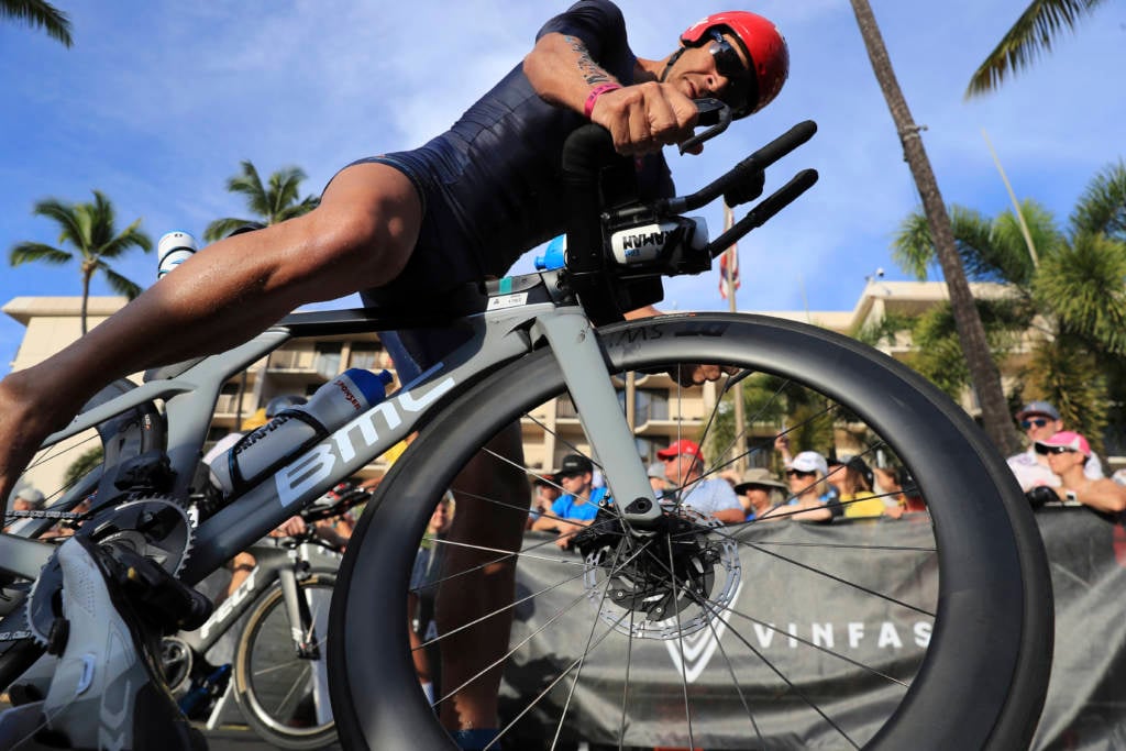 Erez Aisenberg, of Israel, jumps on his bike at the Ironman World Championship