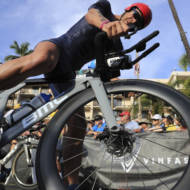 Erez Aisenberg, of Israel, jumps on his bike at the Ironman World Championship