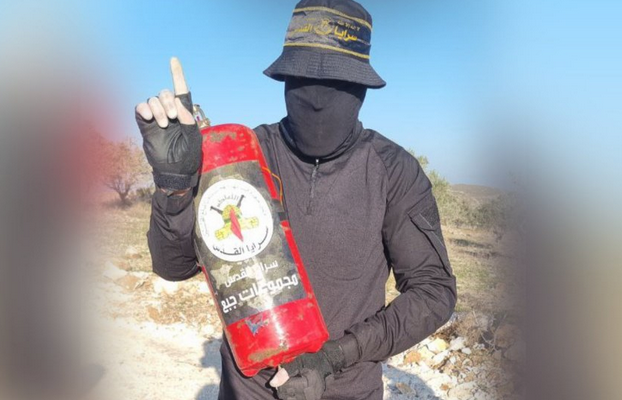 Palestinian Islamic Jihad member with a fire extinguisher rigged as an IED