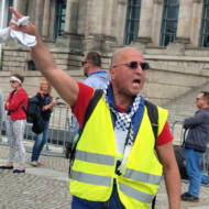Convicted German Holocaust denier Reza Begi inciting demonstrators outside the German parliament in Berlin in May 2020