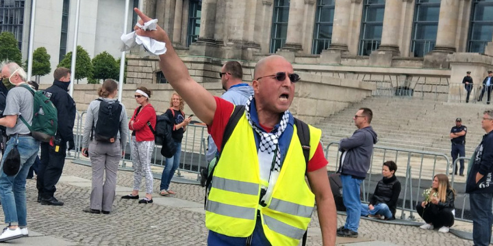 Convicted German Holocaust denier Reza Begi inciting demonstrators outside the German parliament in Berlin in May 2020