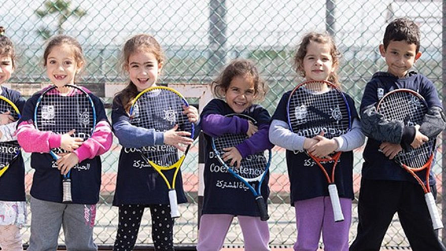 Players from the Israel Tennis & Education Centers wear coexistence-themed shirts
