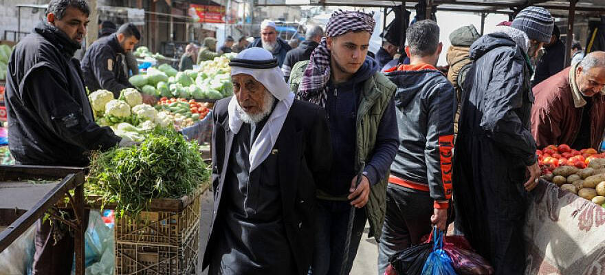 Palestinians shop in the market in Rafah