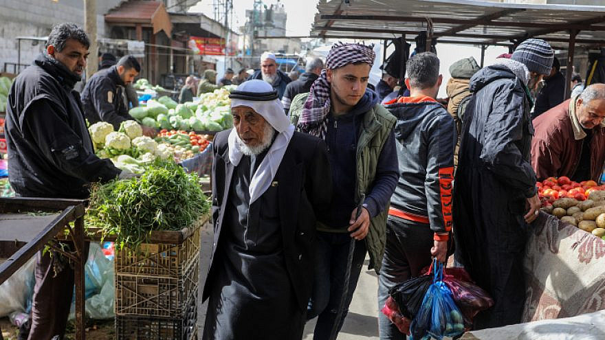 Palestinians shop in the market in Rafah