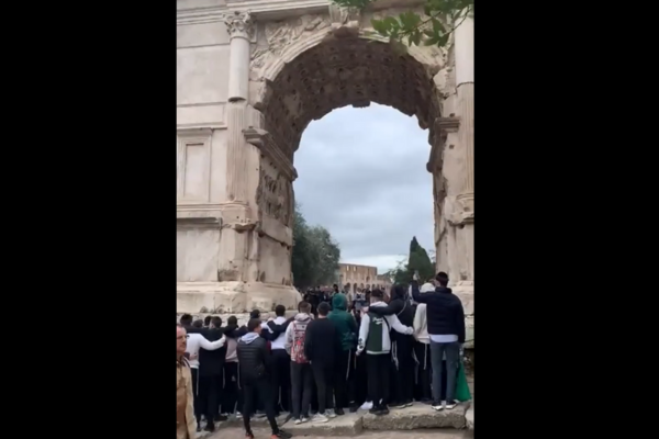 A group of Jewish people sing "If I Forget You, Oh Jerusalem" at the Arch of Titus in Rome.