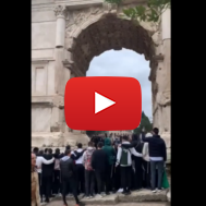 A group of Jewish people sing "If I Forget You, Oh Jerusalem" at the Arch of Titus in Rome.