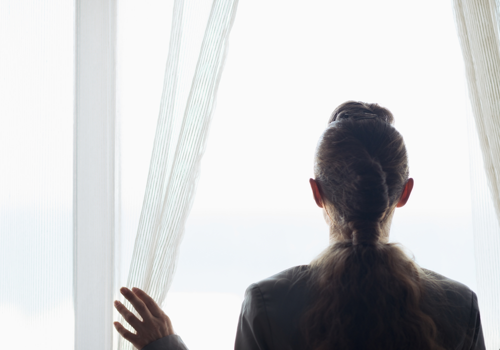 woman looking out the window