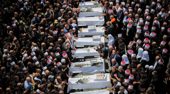 funeral of Druze children hit in Hezbollah rocket attack.