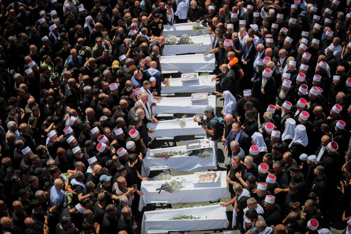 funeral of Druze children hit in Hezbollah rocket attack.