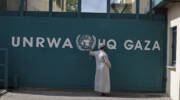 A man waits outside UNRWA headquarters in Gaza City. (FLASH90/Wissam Nassar)