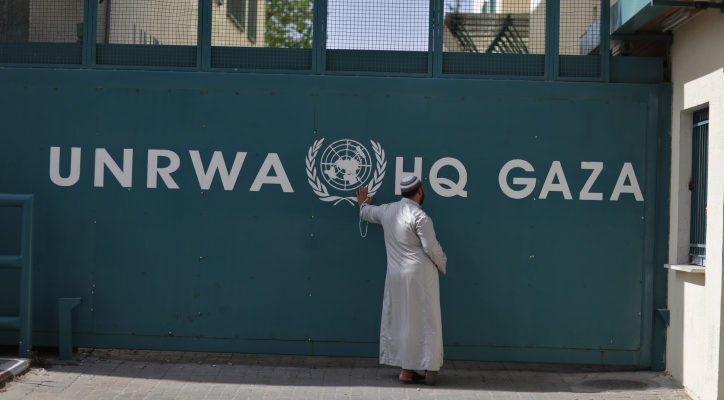 A man waits outside UNRWA headquarters in Gaza City. (FLASH90/Wissam Nassar)