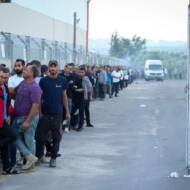 Workers from Gaza stand in line to enter Israel