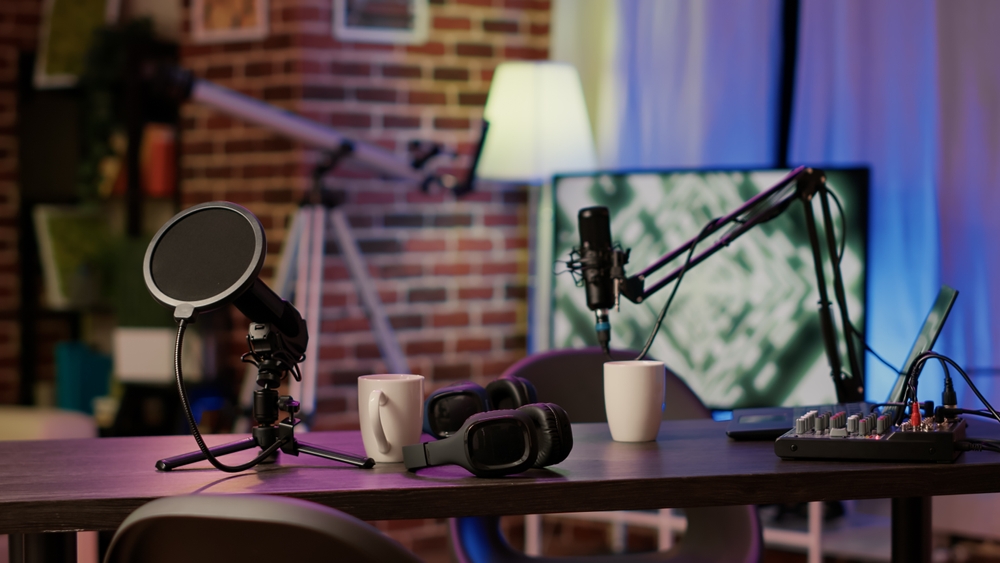 Closeup of headphones and professional microphone on empty vlogger desk