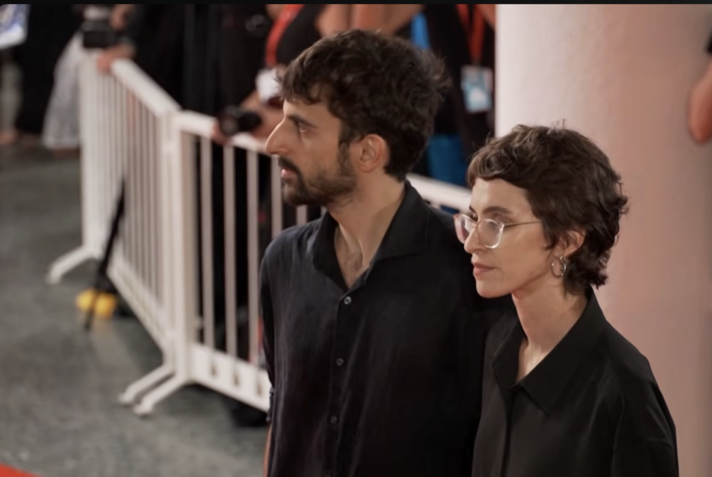 Yuval Abraham and Rachel Szor at the Venice Film Festival and receive an award for their Gaza documentary NAZA. (September 11, 2026)